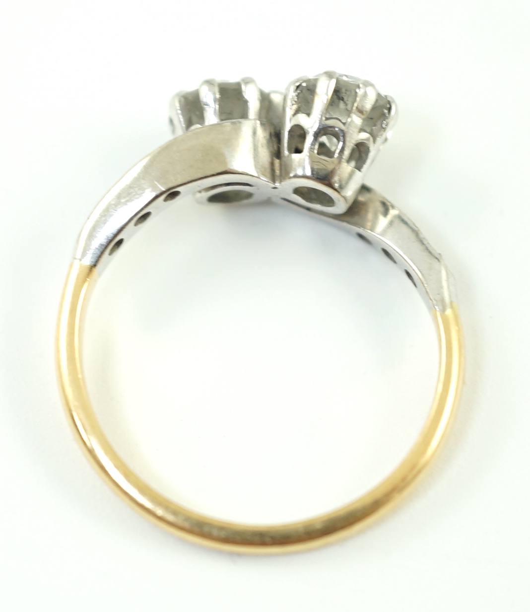 A mid 20th century 18ct gold, platinum and two stone diamond set crossover ring